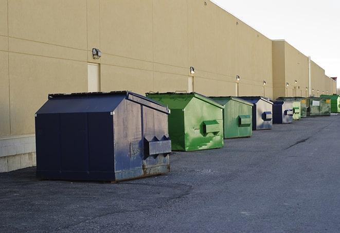 a compact construction dumpster being emptied by a waste disposal truck in Arlington, WA